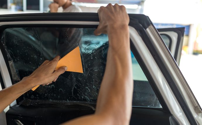 Technician,Installing,Car,Window,Tint.,Car,Window,Tinting,Series.,Car