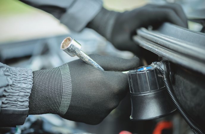Worker,Is,Installing,A,Car,Alarm,Siren,Under,The,Hood